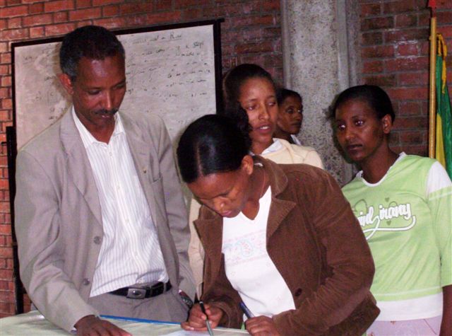 student signing bank book